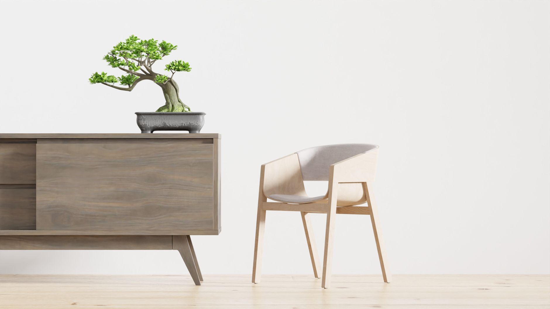 A modern minimalist interior featuring a wooden cabinet with a bonsai plant and a sleek chair, ideal for contemporary decor lovers.